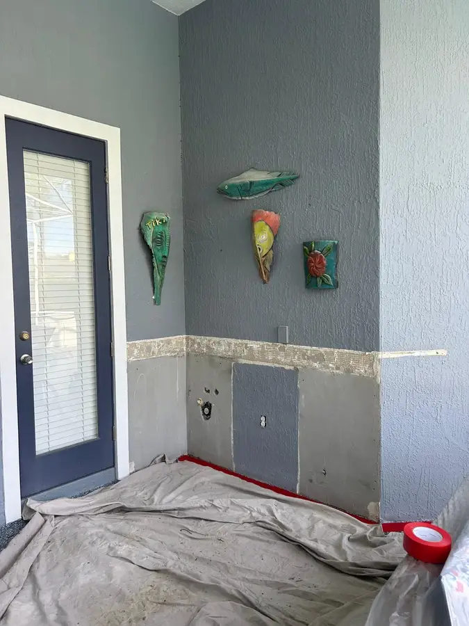 Lanai wall with damaged stucco cut back to the lath before repair by ZLS Contractors